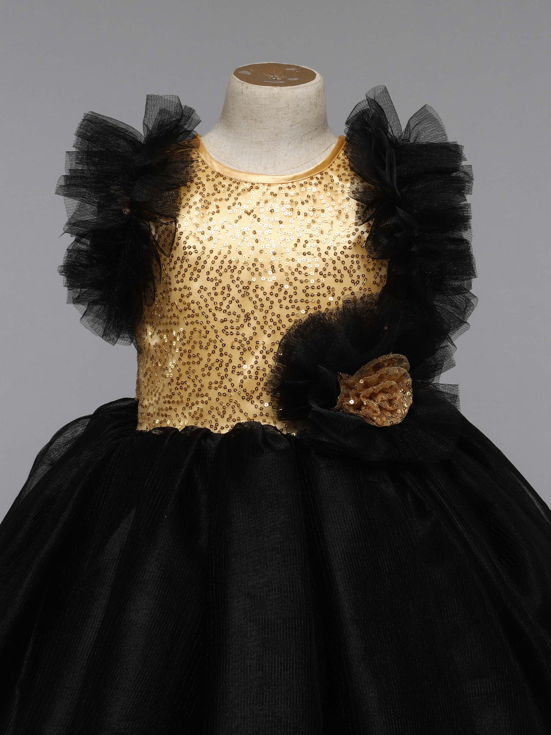 The gown features a black gold printed pattern, which adds a touch of  traditional artistry to